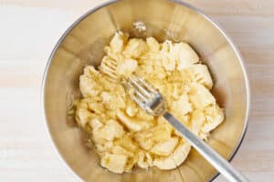 Mashed banana. Step by step recipe. Homemade Banana bread. Top view, white wooden table.