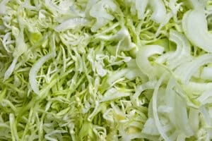 Finely chopped cabbage and onions during cooking of salad