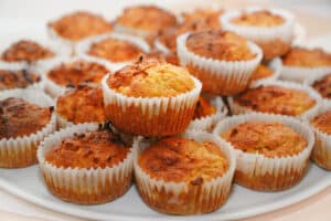 homemade carrot muffins in paper sleeves served on a white tray, selected focus, narrow depth of field