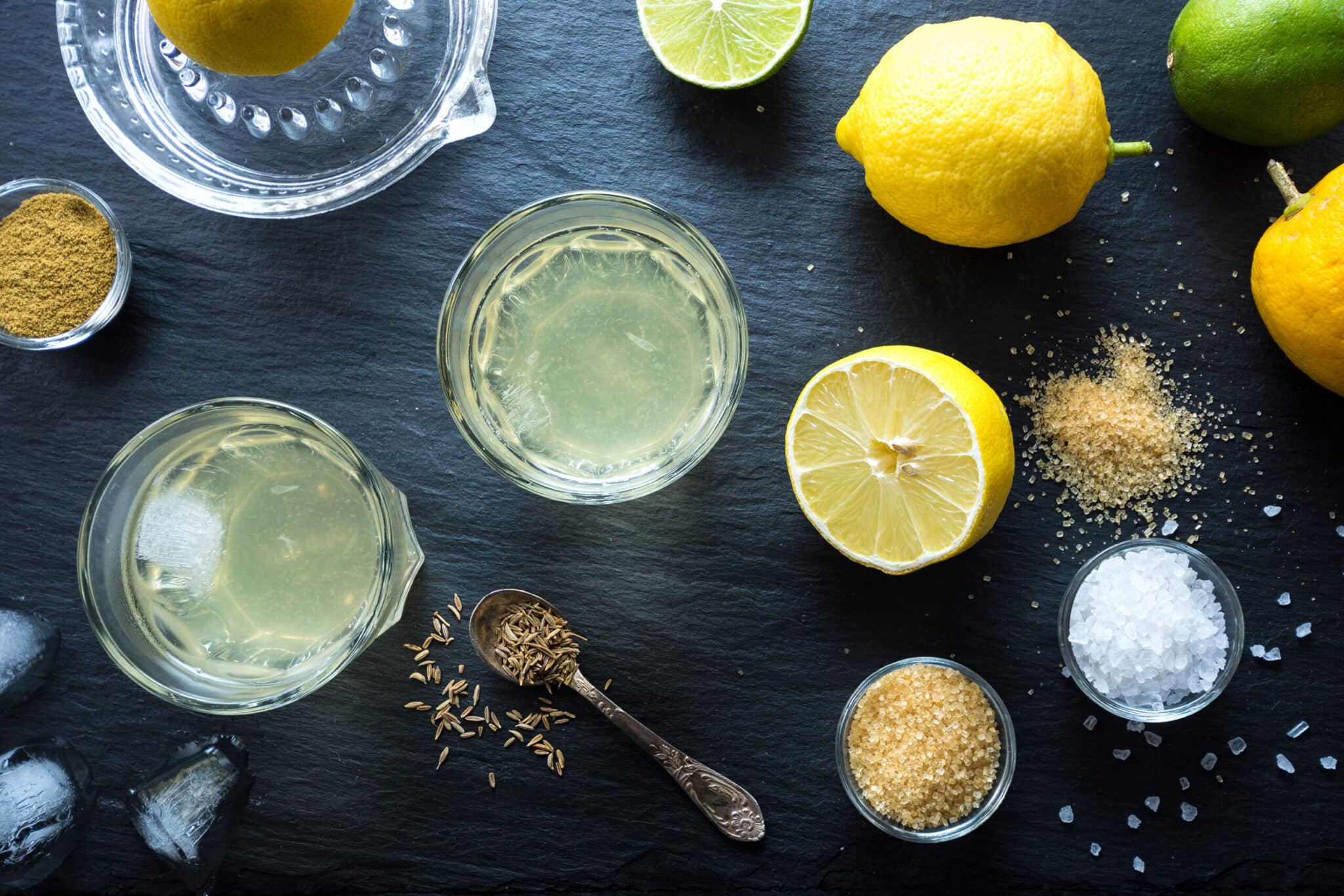 Nimbu Pani Indian lemonade, refreshing drink for hot days. Home made natural isotonic made with water, lemon juice, sugar, salt and cumin. Top view.