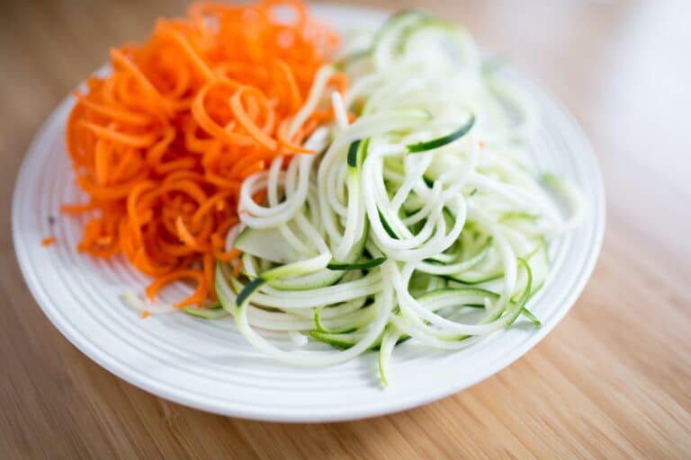 white plate with spiralized carrots and zucchini