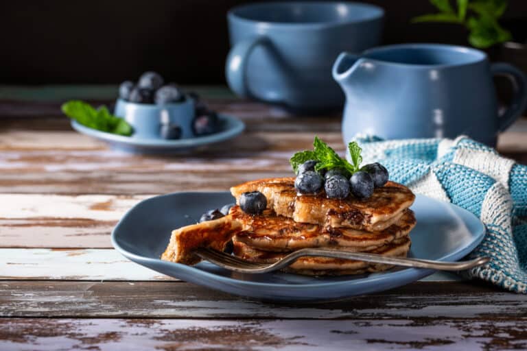 Delicious pancakes with honey and blueberries.