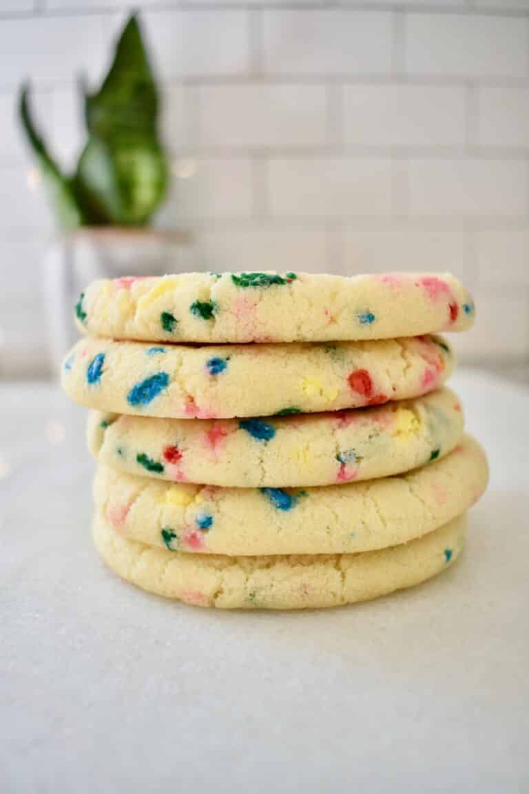 Funfetti cookies arranged in a stack in vertical image