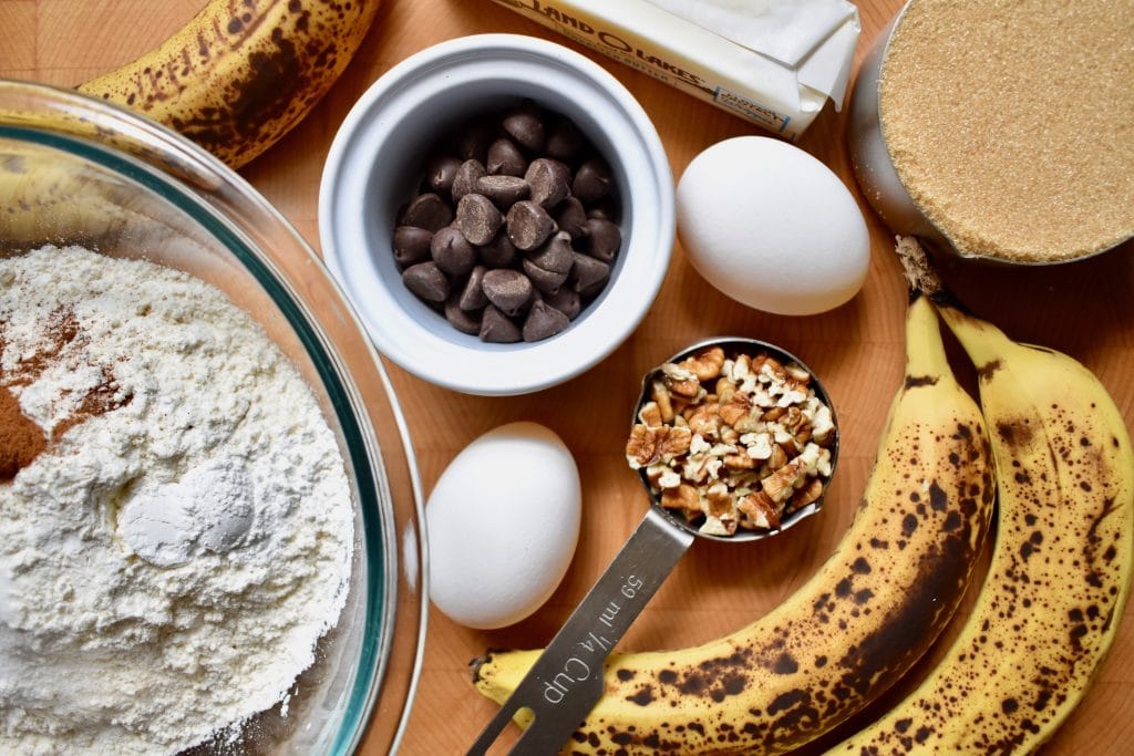 ingredients for banana bread: overripe bananas, flour, eggs, chocolate chips