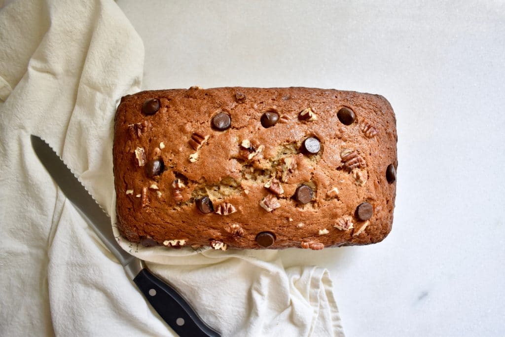 overhead shot of a banana bread loaf with chocolate chips and pecans