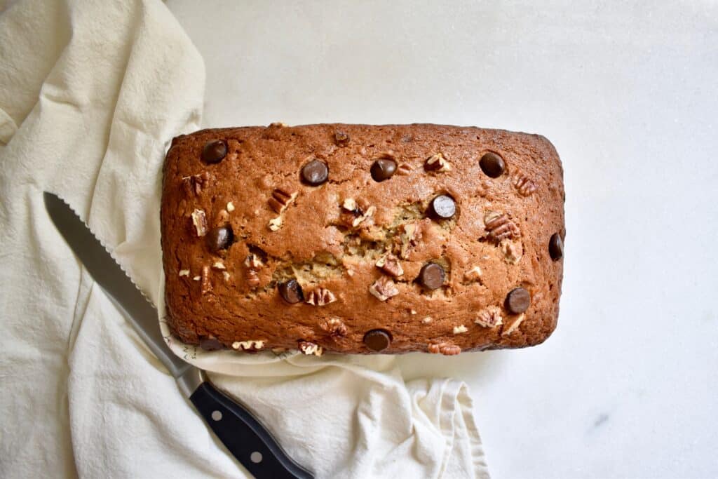 overhead shot of a banana bread loaf with chocolate chips and pecans