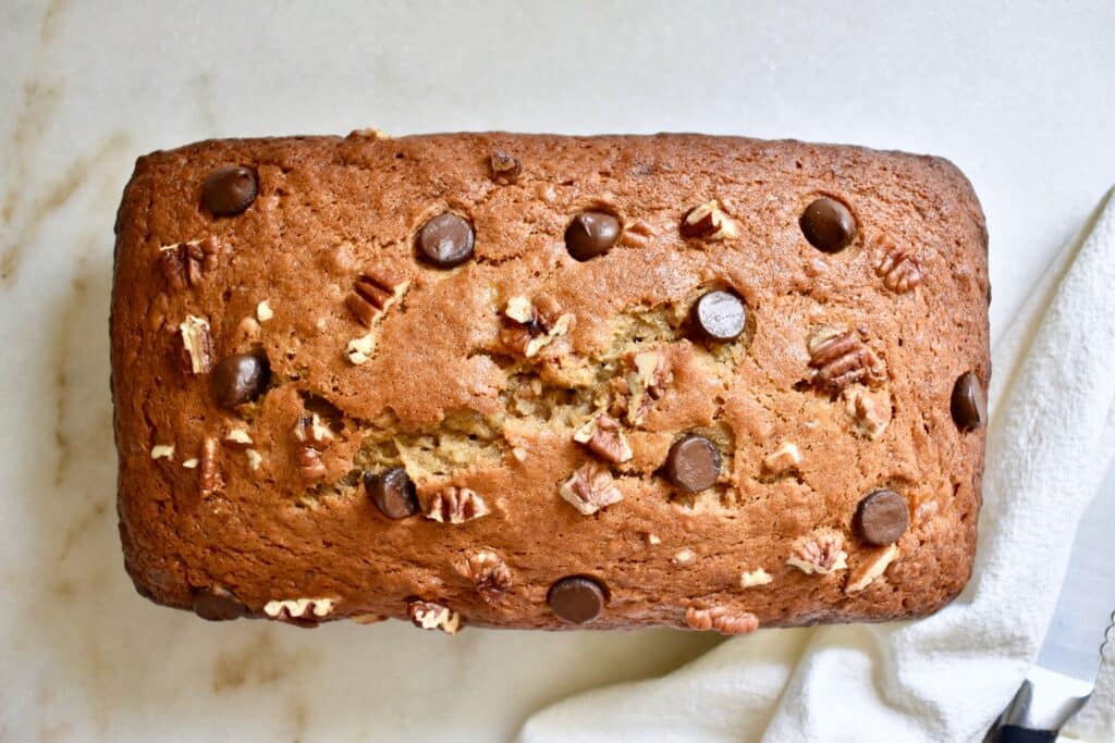 overhead shot of the finished banana bread loaf on white background