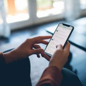 cropped image of a person's hands holding a phone with Plan to Eat on the screen