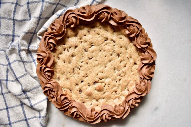 overhead shot of circular cookie cake with chocolate frosting detail around edge