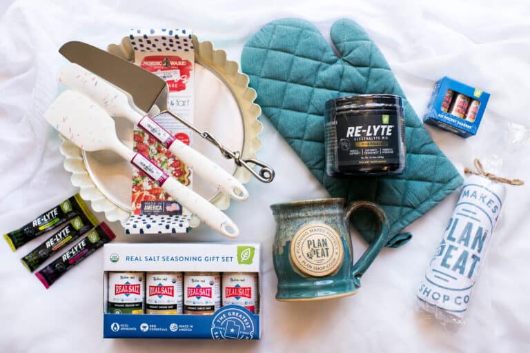 flat lay of giveaway items, including: baking mitt, Redmond Real Salt shakers, spatulas, coffee mug and baking tart