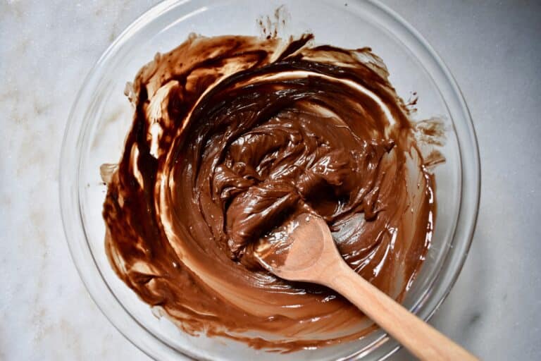 overhead shot of melted butter and chocolate chips in glass bowl