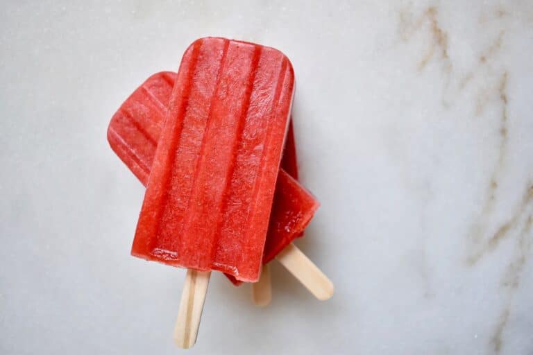 overhead shot of two strawberry popsicles sitting on top of each other