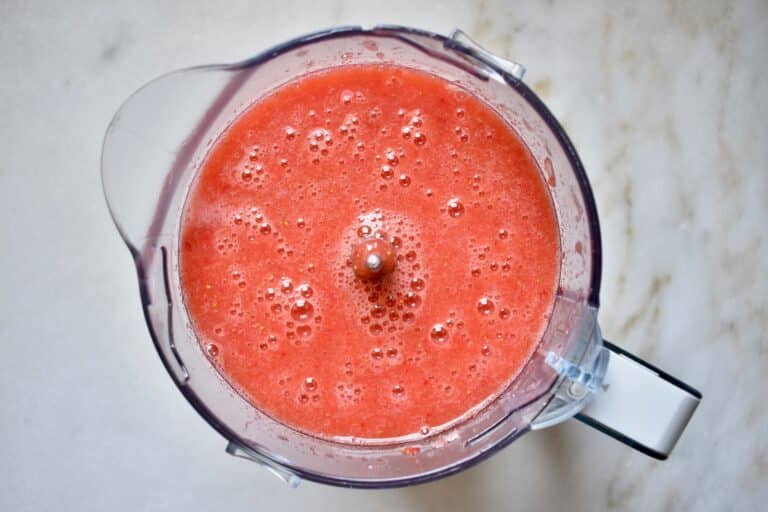 overhead shot of popsicle ingredients blended in a blender