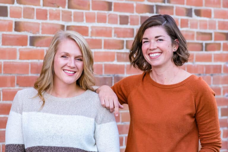 Riley and Roni in front of a brick background