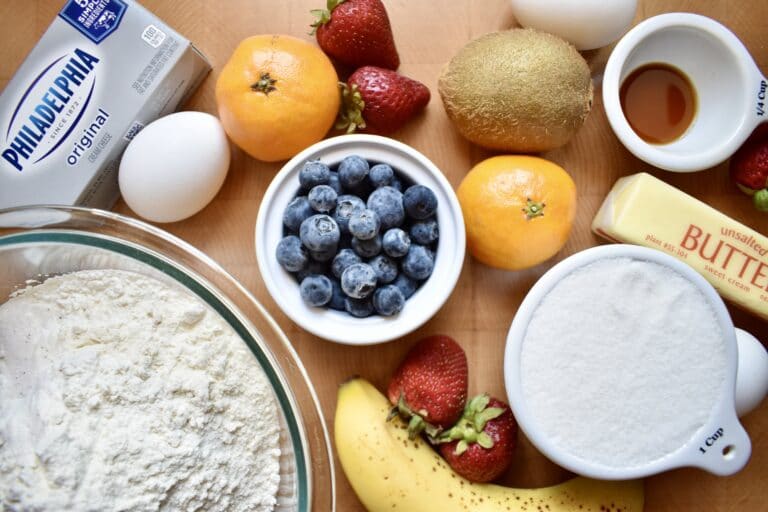 pre-portioned ingredients for fruit pizza including cream cheese, flour, blueberries, and butter