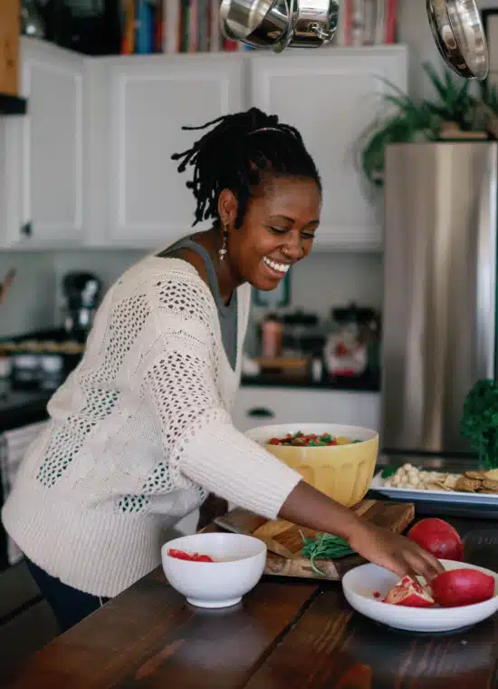 image of young black woman preparing a salad