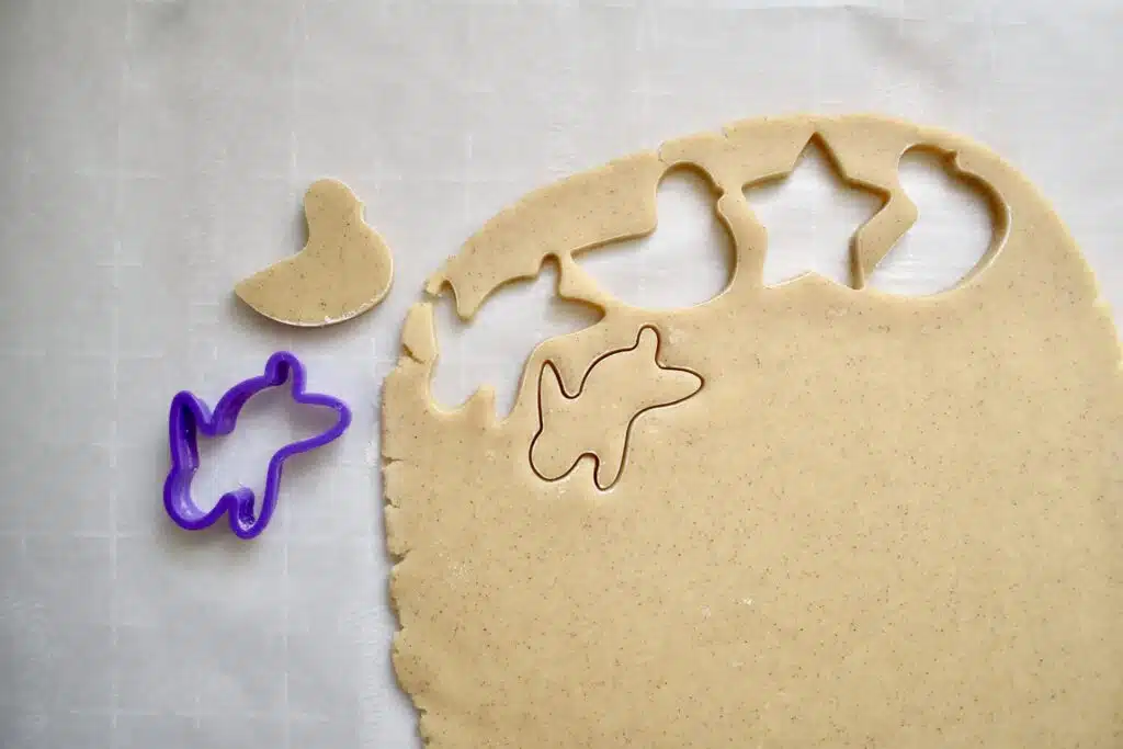 overhead image of cookie dough rolled flat with small bunny cookies cut out