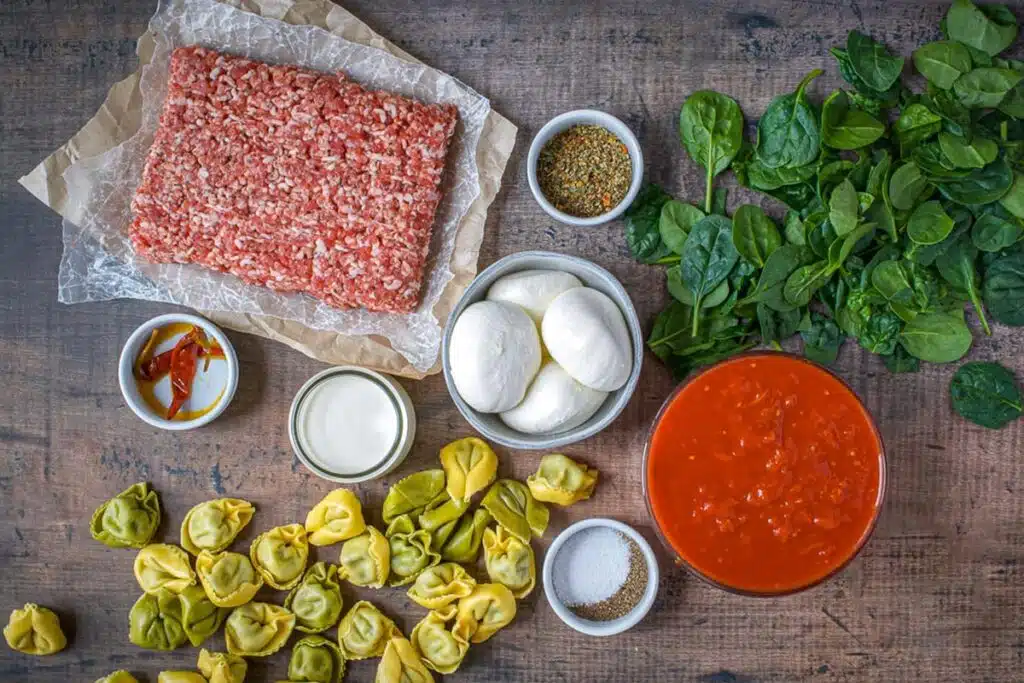 overhead view of ingredients laid out for tortellini burrata recipe