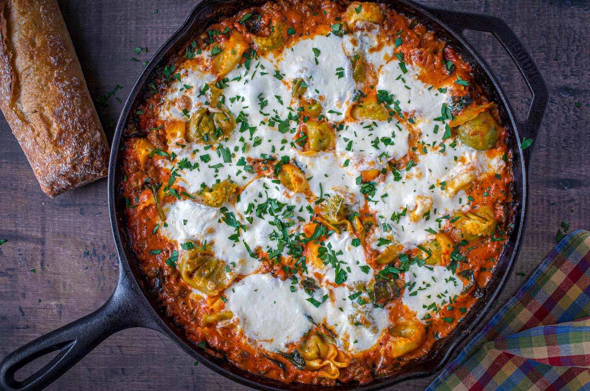overhead view of tortellini burrata recipe in a cast iron skillet
