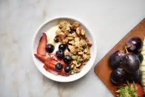 overhead shot of homemade granola in a parfait with yogurt and fruit