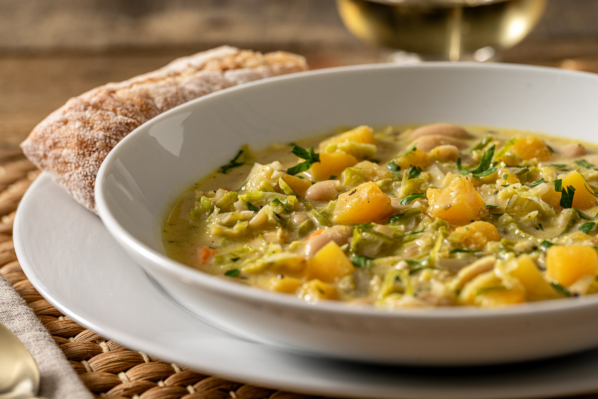 close up image of white bean stew in bowl